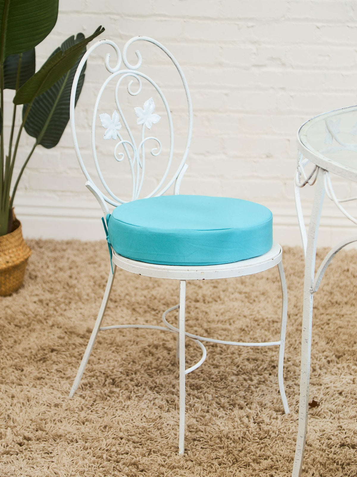 Vintage Wrought Iron Patio Dining Table with Leaf Motif Aqua Cushions and Glass Top